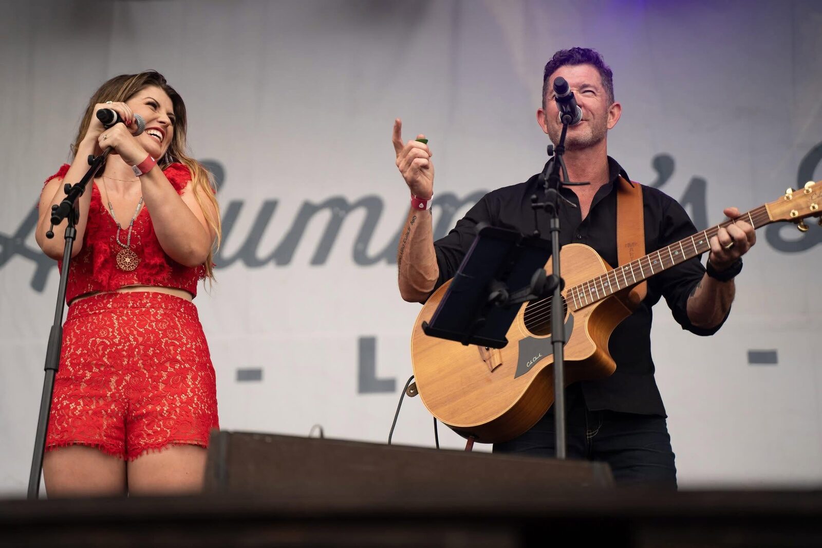 Two vocalists performing together on stage
